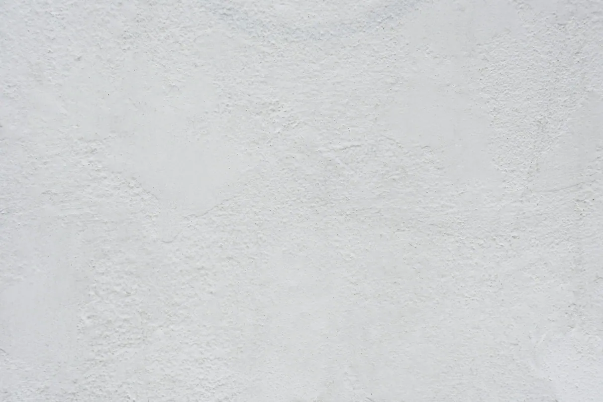 Close view of a white plastered wall with a soft, uneven hand-finished texture